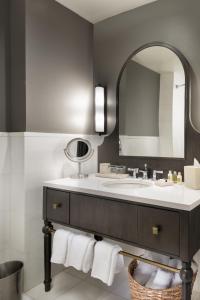 a bathroom with a sink and a mirror at Hotel Valencia Riverwalk in San Antonio +55 photos