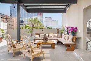 a living room with a couch and chairs at Guadalupe Inn in Mexico City