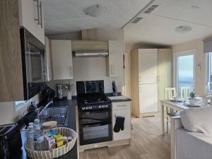 a kitchen with a stove and a counter top at Snug on the Teviot in Hawick +9 photos