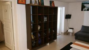 a book shelf in a living room with a couch at Billet Junior in Fredrikstad