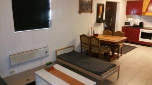 a living room with a table and a bed and a television at Billet Junior in Fredrikstad