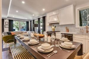 a kitchen with a table with plates and silverware at Luxe Boston Condo Near T in Boston