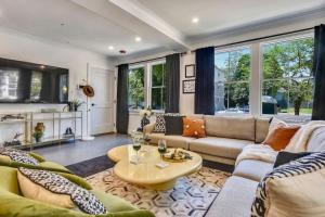 a living room with a couch and a table at Luxe Boston Condo Near T in Boston