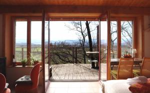 a room with a large glass door leading to a balcony at La Forge - calme absolu avec vue sur les Pyrenées in Villarzel-du-Razès +7 photos