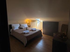 a bedroom with a bed with two towels on it at VASILICA Apartments in Ierissos