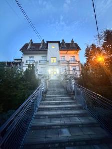 a building with stairs leading up to a building at Vila Cirkovic - 200m od mermernog setalista in Soko Banja