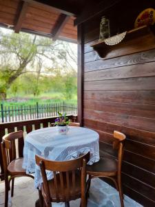 a table with a white table cloth on a porch at Selsko domacinstvo Nevena in Kumanovo +29 photos