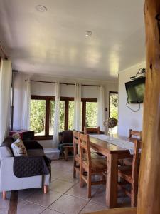 a living room with a table and a couch at Cabaña Coihue in Pucará