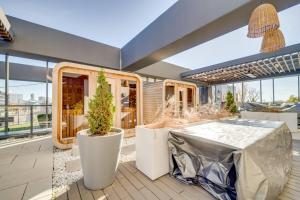 a patio with a table and potted plants at Stylish Open Concept Suite in Central KW in Kitchener