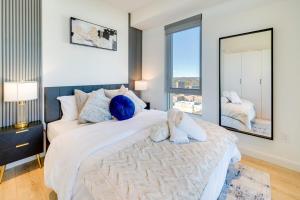 a bedroom with a large bed with two stuffed animals on it at Stylish Open Concept Suite in Central KW in Kitchener