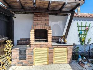 a brick oven with a sink in a backyard at Vila Sebas in Zărneşti