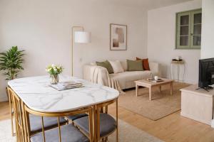 a living room with a couch and a table at Le Green de Bellême in Bellême
