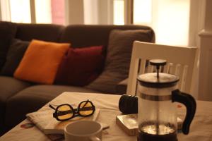 a table with a coffee maker and glasses on it at Lyon Standing Historic City Apartment in Lyon +26 photos