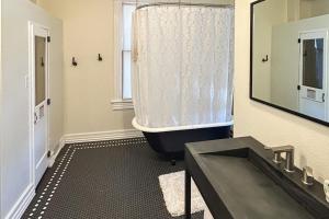 a bathroom with a tub and a large mirror at Addie House in Lead +26 photos