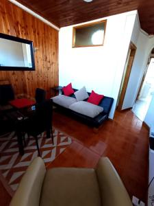 a living room with a couch and a table at Departamento Lido Central in El Cerrillo