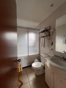 a bathroom with a white toilet and a sink at Cabaña Pino Oregón in Pucará +30 photos