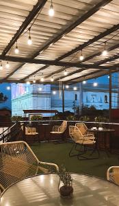 a patio with a table and chairs and lights at La Casa de Mamapán Hotel Colonial Ahuachapan in Ahuachapán +18 photos