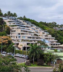 a large apartment building on a hill with a parking lot at Ora Stay in Papeete