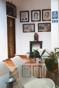 a dining room with a glass table and chairs at La Casa de Mamapán Hotel Colonial Ahuachapan in Ahuachapán