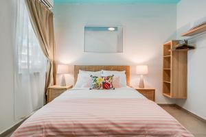 a bedroom with a large bed with two lamps at Casa Piccioni by Otium in San Juan