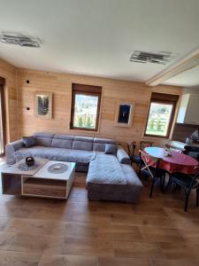 a living room with a couch and a table at Митровилица - Mitrovilica in Mitrovac
