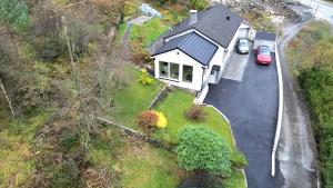 a house with a car parked in front of it at Fjordclaw SNM- adjoining the Bergen city & Nature, Free parking in Bergen +3 photos