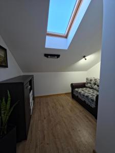 a living room with a couch and a window at Sense Loft in Leskovac