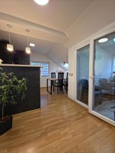 an open living room and dining room with sliding glass doors at Sense Loft in Leskovac