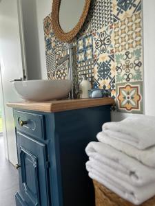 a bathroom with a sink and a mirror at Backyard Cottage in Răhău