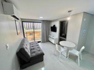 a living room with a couch and a table at Cabo Branco - Fortune in Tambaú