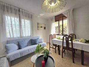a living room with a blue couch and a table at Apartamento El Hayedo 20808 in Argoños