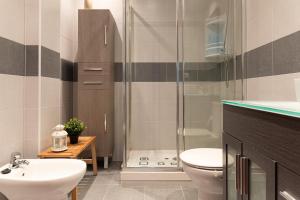 a bathroom with a shower and a sink and a toilet at Apartamento en Bádames in Bádames +17 photos