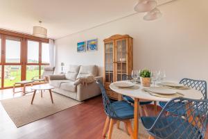 a living room with a table and chairs and a couch at Apartamento en Bádames in Bádames