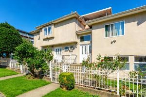 a building with a fence and trees in front of it at Cozy Home in Vancouver in Vancouver