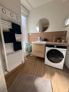 a kitchen with a dishwasher and a sink in it at Les Trois Mouettes - Grand appartement familial in Saint-Brieuc