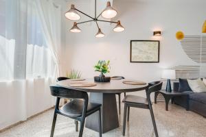 a dining room with a table and chairs and a couch at Casa Piccioni by Otium in San Juan +208 photos