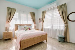 a bedroom with a bed and a large window at Casa Piccioni by Otium in San Juan