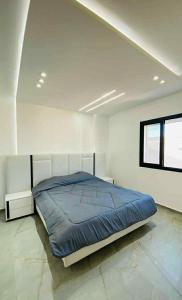 a bedroom with a large bed in a white room at Villa SAM in Fafou +7 photos