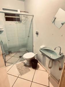 a bathroom with a sink and a toilet at Hotel América in Ivaiporã