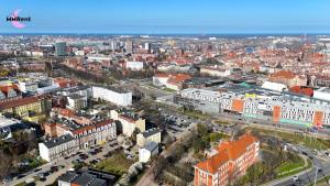an aerial view of a city with buildings and cars at MMRent Orange Room in Gdańsk +1 photo