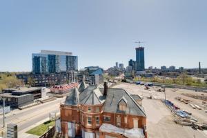 an old brick building with a city in the background at Modern Downtown Condo with Gym in Kitchener