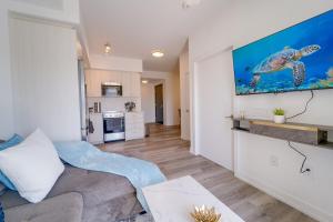 a living room with a couch and a television on a wall at Modern Downtown Condo with Gym in Kitchener