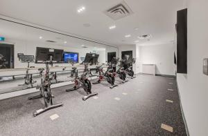 a gym with rows of exercise bikes in a room at Modern Downtown Condo with Gym in Kitchener