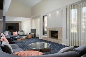 a living room with couches and a fireplace at Courtyard by Marriott Albuquerque Airport in Albuquerque