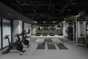 a gym with a treadmill and exercise equipment in it at The Stoneleigh, Autograph Collection in Dallas