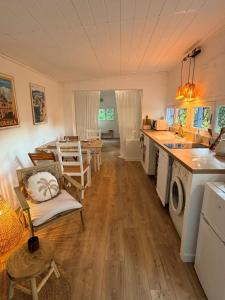 a kitchen and living room with a sink and a stove at Caseddu Corse - Maison Typique in Cauro +10 photos