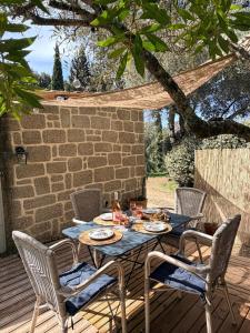 a blue table and chairs on a wooden deck at Caseddu Corse - Maison Typique in Cauro