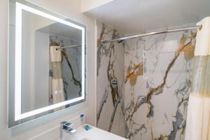 a bathroom with a mirror and a sink at Central Phoenix Hotel in Phoenix +52 photos