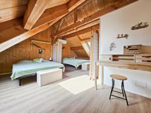 a bedroom in a attic with a bed and a stool at La Maison des Jeux in Saint-Maur