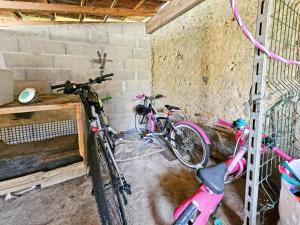 two bikes parked in a room with a wall at La Maison des Jeux in Saint-Maur